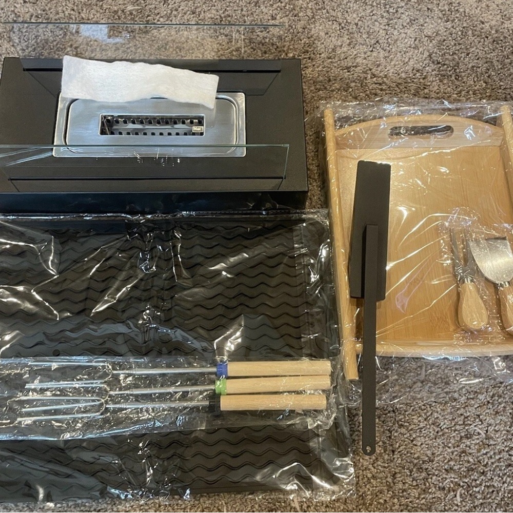 portable tabletop fire pit with multiple attachments. opened to confirm contents